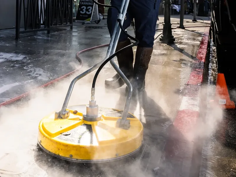 APEX pressure washing a hard surface with a rotary cleaner on the Central Coast